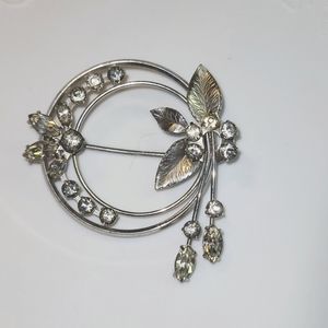 Rhinestone and silver tone brooch by Krementz.